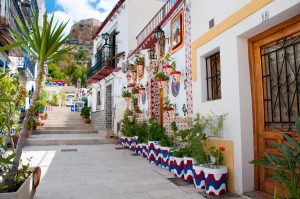 A street of white, Spanish-style houses.